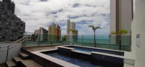 a balcony with a swimming pool on top of a building at Brisa Calma Premium Flat - PontaNegra in Natal