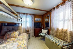 a bedroom with a bed and a tv in a room at 144 Heritage Woods Lane in Winthrop +15 photos