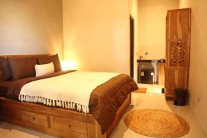 Postel nebo postele na pokoji v ubytování Umah Sekar Inn Uluwatu