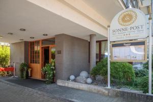 a sign for some post in front of a building at Hotel Restaurant Sonne-Post in Murrhardt +16 photos