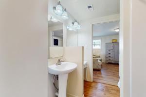 a bathroom with a sink and a mirror at Macs Fish Camp in Dauphin Island +11 photos