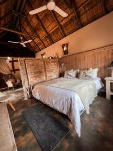 a bedroom with a bed and a ceiling fan at Rustenzicht Lodge and Wedding Venue in Rustenburg
