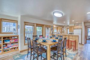a kitchen and dining room with a table and chairs at Seas the Day in Shorepine in Pacific City