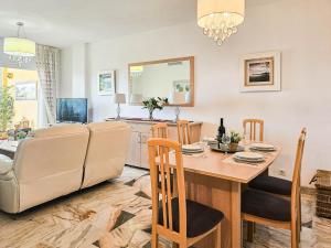 a kitchen and living room with a table and a couch at Two bedroom apartment with pool & sea views in Mijas Costa