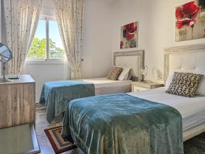 a bedroom with two beds and a window at Two bedroom apartment with pool & sea views in Mijas Costa +34 photos