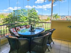 a patio with a table and chairs on a balcony at Two bedroom apartment with pool & sea views in Mijas Costa