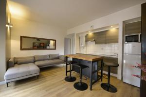 una sala de estar con un sofá y una mesa en T2, Centre ville, Gare 600m, Prox Lille, Terrasse, en Tourcoing