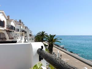 a view of the ocean from the balcony of a building at PalmBreeze in Vilanova i la Geltrú