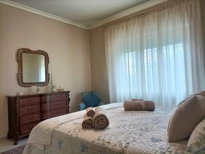a bedroom with a bed with a mirror and a dresser at Casa Vacanze Annunziata Relax in Lucca