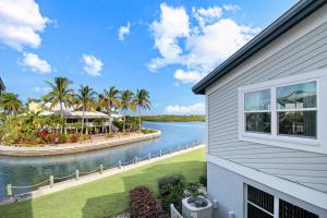 a house with a view of a body of water at 2nd floor bayfront Siesta Key condo with private beach access in Siesta Key
