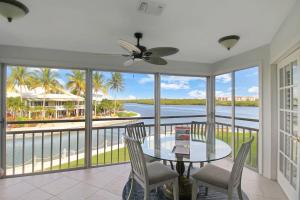 a dining room with a view of the water at 2nd floor bayfront Siesta Key condo with private beach access in Siesta Key