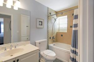 a bathroom with a sink and a toilet and a tub at 2nd floor bayfront Siesta Key condo with private beach access in Siesta Key +27 photos