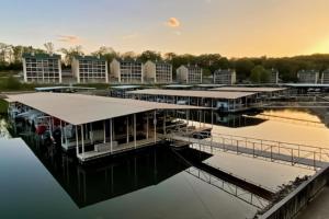 a marina with a dock and buildings on the water at The Southwood Splash in Lake Ozark