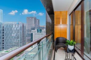 a balcony with a chair and a view of a city at Fa万濠国际服务公寓 in Guangzhou