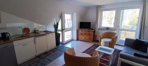 a kitchen with a sink and a table with chairs at Appartements an der Kaiserpfalz - Königshof in Forchheim