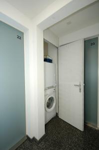a laundry room with a washing machine and a washer at Cute studio in the city center - Stork 23 in Zürich