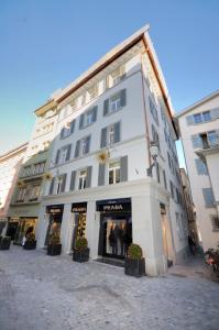 a large white building with a store front at Cute studio in the city center - Stork 23 in Zürich