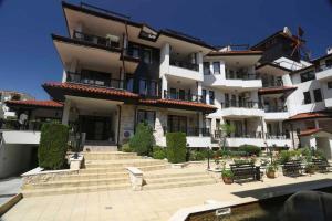 a large building with stairs in front of it at Sozopol Dreams Apartments in Sozopol