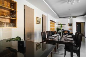 a dining room with a long table and chairs at Royal SPA Massarossa Pool Villa Pattaya-23 in Pattaya Central