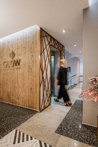 a person walking through a lobby of a building at Glow Boutique Hotel & Suites in Sarandë +73 photos
