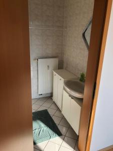 a small bathroom with a sink and a toilet at helle 1Raum Wohnung Apartment mit Balkon und Küche in Dresden