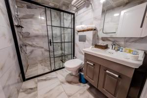a bathroom with a shower and a toilet and a sink at Rubby Kadıköy in Istanbul +36 photos