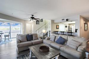 a living room with a couch and a table at Bayfront 3BR 2nd floor Siesta Key condo with private beach access in Siesta Key