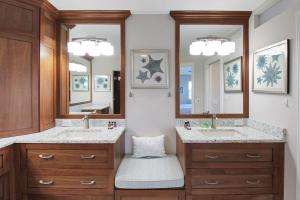 a bathroom with two sinks and two mirrors at Bayfront 3BR 2nd floor Siesta Key condo with private beach access in Siesta Key +46 photos