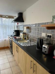 a kitchen with a sink and a counter top at Ancaire Cottage Kilbronogue. Schull in Schull