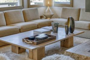 a living room with a couch and a coffee table at Chalet Boucle in Megève