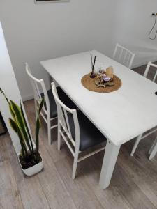 a white table with chairs and a hat on it at RCH Roma in Chacabuco +6 photos