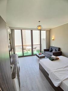 a bedroom with a bed and a living room with a couch at Bali studio in Hurghada