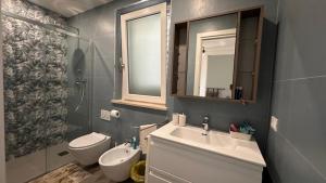 a bathroom with a sink and a toilet and a mirror at VILLA SABRINA VICINA al MARE in Terracina +43 photos