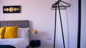 a bedroom with a bed and a black floor lamp at Prestige Stays Cardiff Modern 1-Bed Apartment near City Centre Wi-Fi & Lockbox Check-In in Cardiff