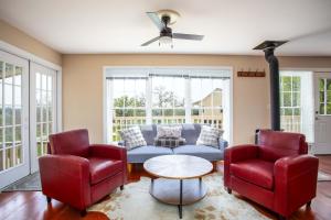 a living room with a couch and two chairs at King Beds Game Room On 290 Large Estate Kitchen in Fredericksburg