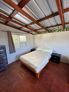 a bedroom with a bed in a room with wooden ceilings at Two levels Las Terrenas near to beaches in Las Terrenas