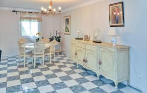 a dining room with a table and a dresser at Cozy Home In Chateaurenard in Châteaurenard