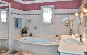 a bathroom with two sinks and a tub at Cozy Home In Chateaurenard in Châteaurenard +17 photos