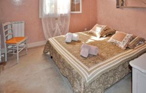 a bedroom with a bed with towels on it at Cozy Home In Chateaurenard in Châteaurenard