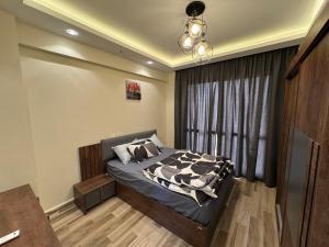 a bedroom with a bed and a window at 212 . Spacious 3BR Apt. 2 Baths Gated Community in Sheikh Zayed