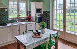 a kitchen with a table with chairs and a table sidx sidx sidx at Gorgeous Home In Plélan-Le-Petit in Plélan-le-Petit