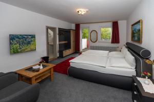 a hotel room with a bed and a couch at Villa Feise in Bad Harzburg
