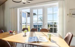 a conference room with a table and a large window at Marina Fiskenæs Feriepark in Gråsten