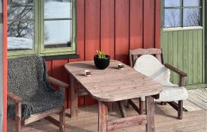 a wooden table and two chairs on a patio at Nice Apartment In Rauland With Wifi in Rauland