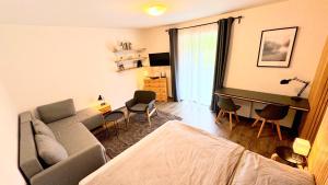 a living room with a couch and a table and chairs at Apartmán u jezera Lipno - Nové in Nová Pec