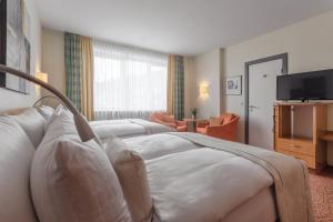TV a/nebo společenská místnost v ubytování Garner Hotel Hamburg - Wandsbek Marktplatz by IHG