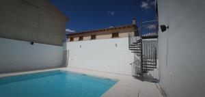 a swimming pool on the side of a building at Hostal La Paz in Ossa de Montiel