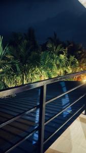 a view of palm trees on a balcony at night at AURA PARK STAY - Kumta in Kumta