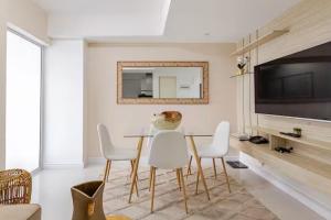 a dining room with a table and chairs and a mirror at Sabrina'sCrib Apartment 2BR by Azure Residences Near Manila International Airport in Manila