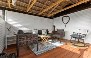 a living room with a table and a chair at Nice Home In Græsted With Wifi in Græsted